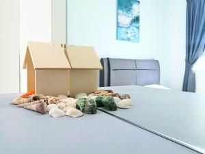 a box and a pile of donuts on a table at Bayu Temiang- Your Urban Retreat in Seremban