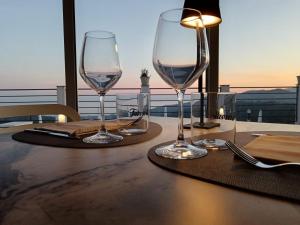 two wine glasses sitting on a table with a view at Tenuta Vallina - Golfo di Policastro in Tortorella