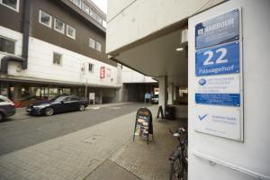 a sign on the side of a building next to a street at Harbour Apartments in Karlsruhe