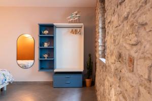 a room with a blue cabinet and a mirror at Ca de l'Angelon - Apartment Sardella in Brenzone sul Garda
