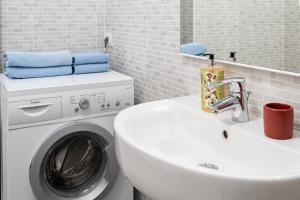 a bathroom with a washing machine and a sink at Ca de l'Angelon - Apartment Sardella in Brenzone sul Garda