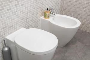 a bathroom with a white toilet and a sink at Ca de l'Angelon - Apartment Sardella in Brenzone sul Garda +20 photos