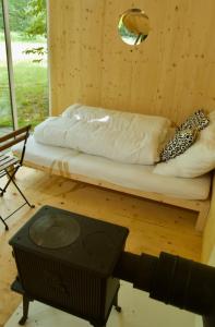 a room with a bed and a television and a table at Tiny house u Dlouhé řeky in Buchlovice