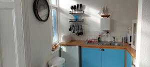 a kitchen with a sink and a clock on the wall at Sail Loft in Brighton & Hove