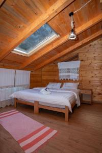 a bedroom with a bed in a wooden cabin at Bee Eco Guest House in Mollʼ e Shoshit