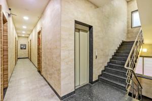 a hallway of a building with stairs and a door at Townhouse OAK Shubhham Regency Near City Centre Salt Lake in Salt Lake City