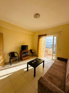 a living room with a couch and a table at Sea view Sarande in Sarandë