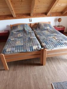 a bed in a room with a wooden floor at Kornati Robinson tourism in Kornati