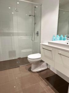 a bathroom with a toilet and a shower and a sink at The Southbank Central Retreat in Melbourne