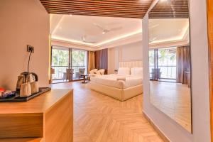 a living room with a bed and a couch in a room at Silver Sand Sea Princess Beach Resort in Port Blair