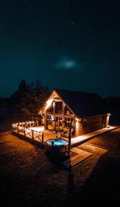 a small cabin with lights on it at night at Tindioru Valley Resort in Rõuge