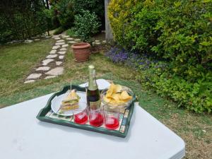 a tray of food and a bottle of wine on a table at LE BETULLE B&B in Romano D'Ezzelino