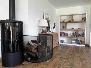 a living room with a bird cage in a room at La Villa Case-Bi in Saint-Germain-sur-Ay +22 photos