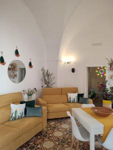 a living room with a couch and a table at Dimora Ludovica in Copertino