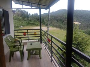 a balcony with a table and chairs and a view at Sports Homestay in Lansdowne