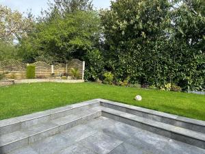 a garden with a lawn with a stairway in it at A luxury double bedroom with ensuite in High Wycombe in Buckinghamshire