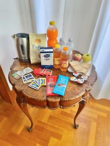 a wooden table with food and drinks on it at Appartamento nel verde fronte ospedale San Pietro, Sant'Andrea in Rome