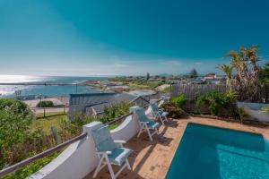 a view of the ocean from a house with a swimming pool at Courtyard@Saxon in Gansbaai