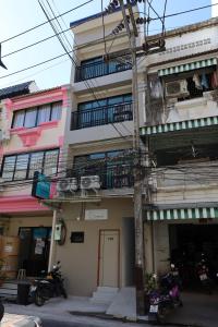 a building with motorcycles parked in front of it at Y House Patong in Patong Beach