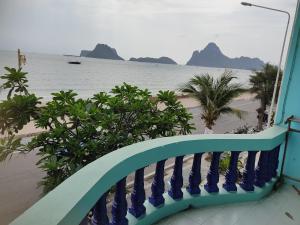 a balcony with a view of the ocean and a beach at Darin's Place in Prachuap Khiri Khan