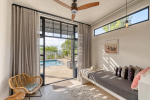 a bedroom with a couch and a large window at De Tafelberg Guesthouse in Cape Town