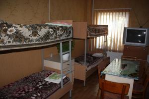 a room with three bunk beds and a television at motel Pid Strihoyu in Kremenchuk