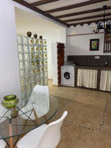 una camera con tavolo in vetro e lavatrice di Apartamento San jose a Jerez de la Frontera