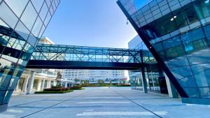 a glass building with a walkway in front of it at Arena MALL Galleria View and Securities Parking1 in Burgas City