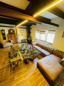 a living room with a couch and a table at Buri`s Seenlandhaus in Hoyerswerda