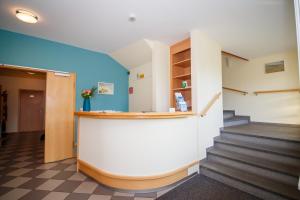 a hallway with stairs and a counter in a building at Künstlerherberge in Spiekeroog