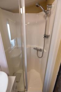 a shower with a glass door in a bathroom at Tattershall VIP Retreat - Hot tub, stunning lakeside views, newly refurbished to an amazing 5 star standard in Tattershall