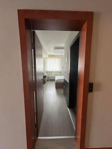 a hallway of a bathroom with a toilet and a mirror at Hotel Bosna 1 in Sarajevo