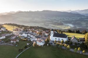 an aerial view of a village with a white church at Frühstückspension Bilgeri in Sulzberg