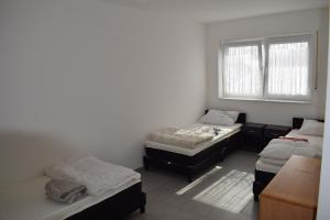 a room with three beds and a window at Apartment in 48599 Gronau Monteurzimmer 2 in Gronau