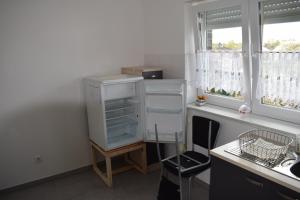 a kitchen with an empty refrigerator next to a window at Apartment in 48599 Gronau Monteurzimmer 2 in Gronau
