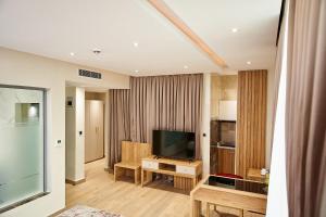 a living room with a flat screen tv at Watercress Signature in Lagos