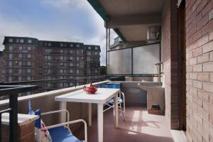 a balcony with a table and a view of a building at Appartamenti RO in Follonica