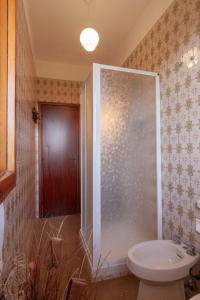 a bathroom with a shower and a toilet in it at Appartamenti RO in Follonica +6 photos