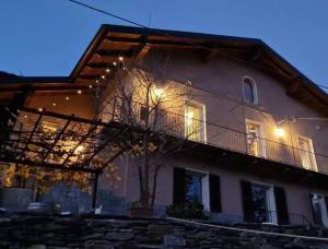 a large house with lights on the side of it at Villa Aurora Sotto Le Stelle in Torre Pellice
