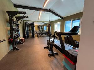 a gym with treadmills and treadleys in a room at Dela in Hvar