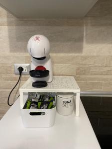 a white coffee maker sitting on a table at Mavi house in Catania +14 photos