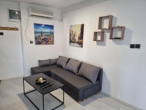 a living room with a couch and a table at Bgd Downtown Hostel in Belgrade