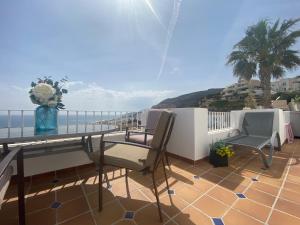 a balcony with a table and chairs and the ocean at RESIDENCIAL OASIS 5 in Mojácar