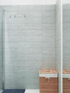 a shower in a bathroom with a gray wall at Historic Old Town Home in Budapest