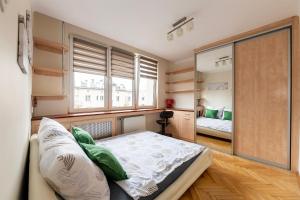 a bedroom with a bed and a large mirror at Student District in the Heart of Łódź&Free Parking in Łódź