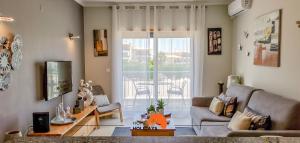 a living room with a couch and a table at #093 Kid Friendly Ocean View with AC, Pool in Albufeira