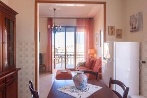 a kitchen and dining room with a table and a refrigerator at Appartamento TL in Follonica