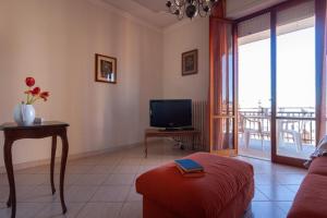 a living room with a couch and a television at Appartamento TL in Follonica