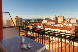 a table on a balcony with a view of a city at Appartamento TL in Follonica