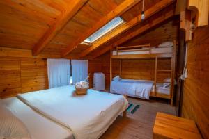 a bedroom with two bunk beds in a cabin at Bee Eco Guest House in Mollʼ e Shoshit